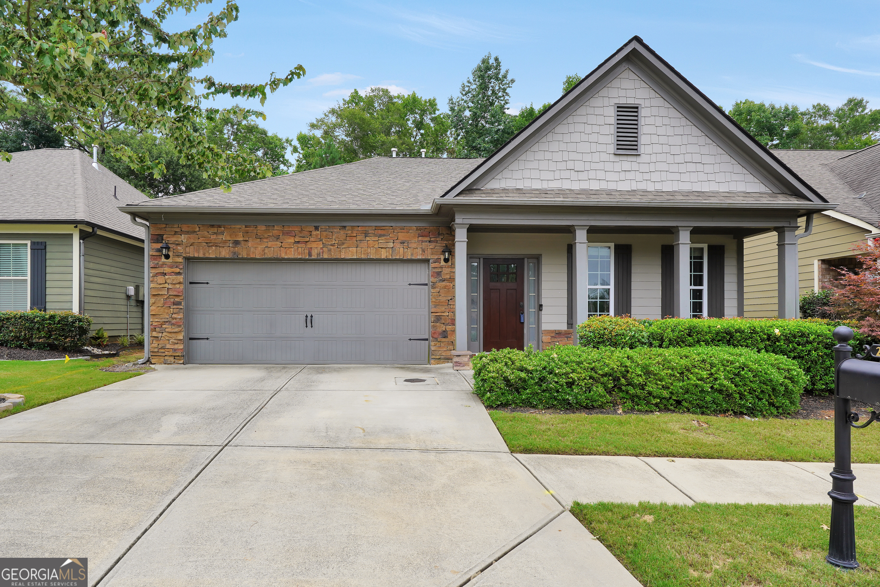 a front view of a house with a yard and garage