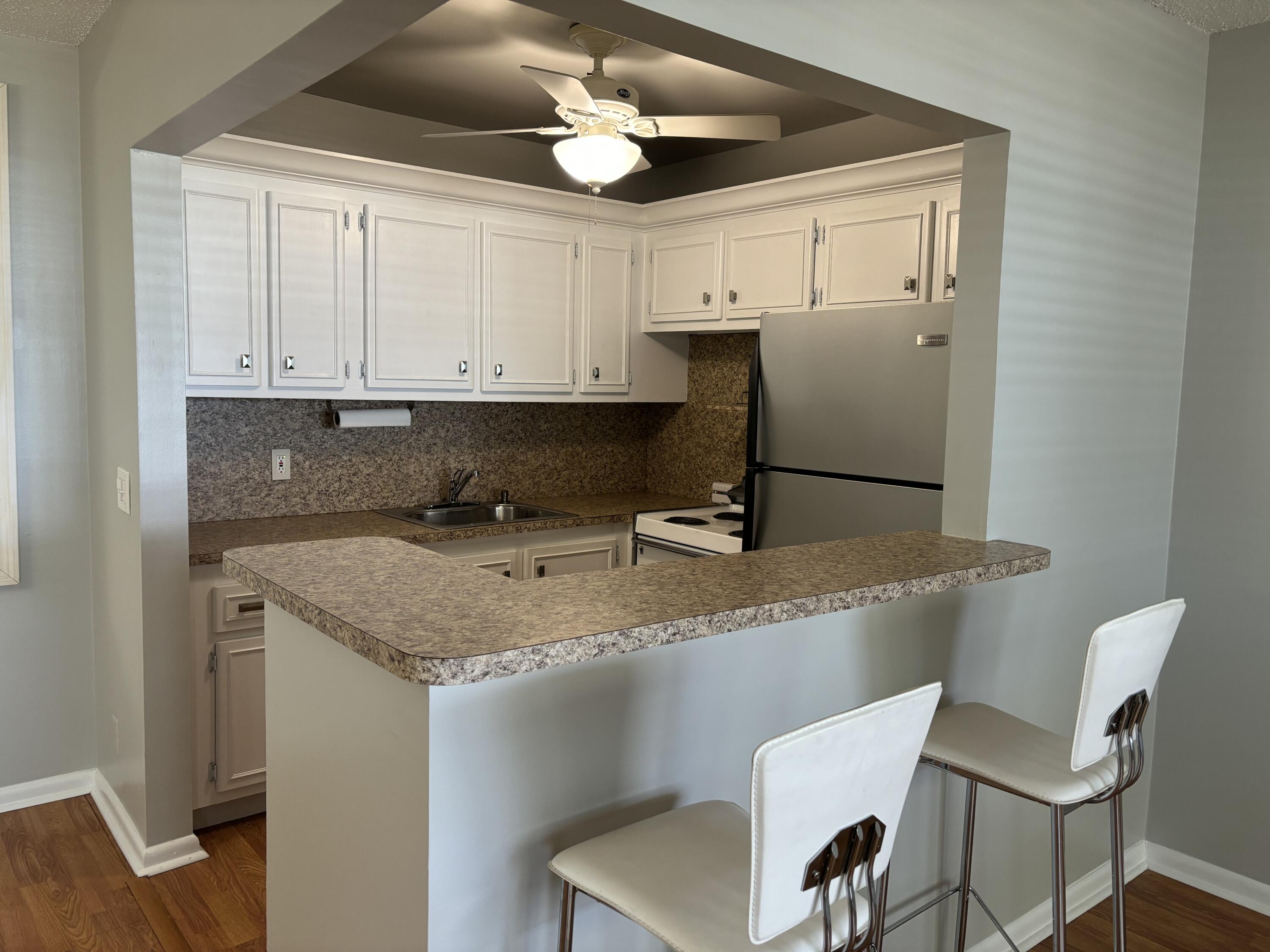 a kitchen with a stove cabinets and a refrigerator