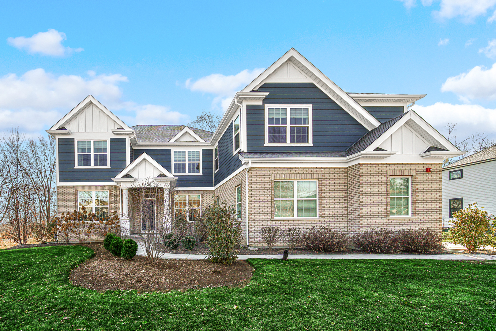 a front view of a house with a yard