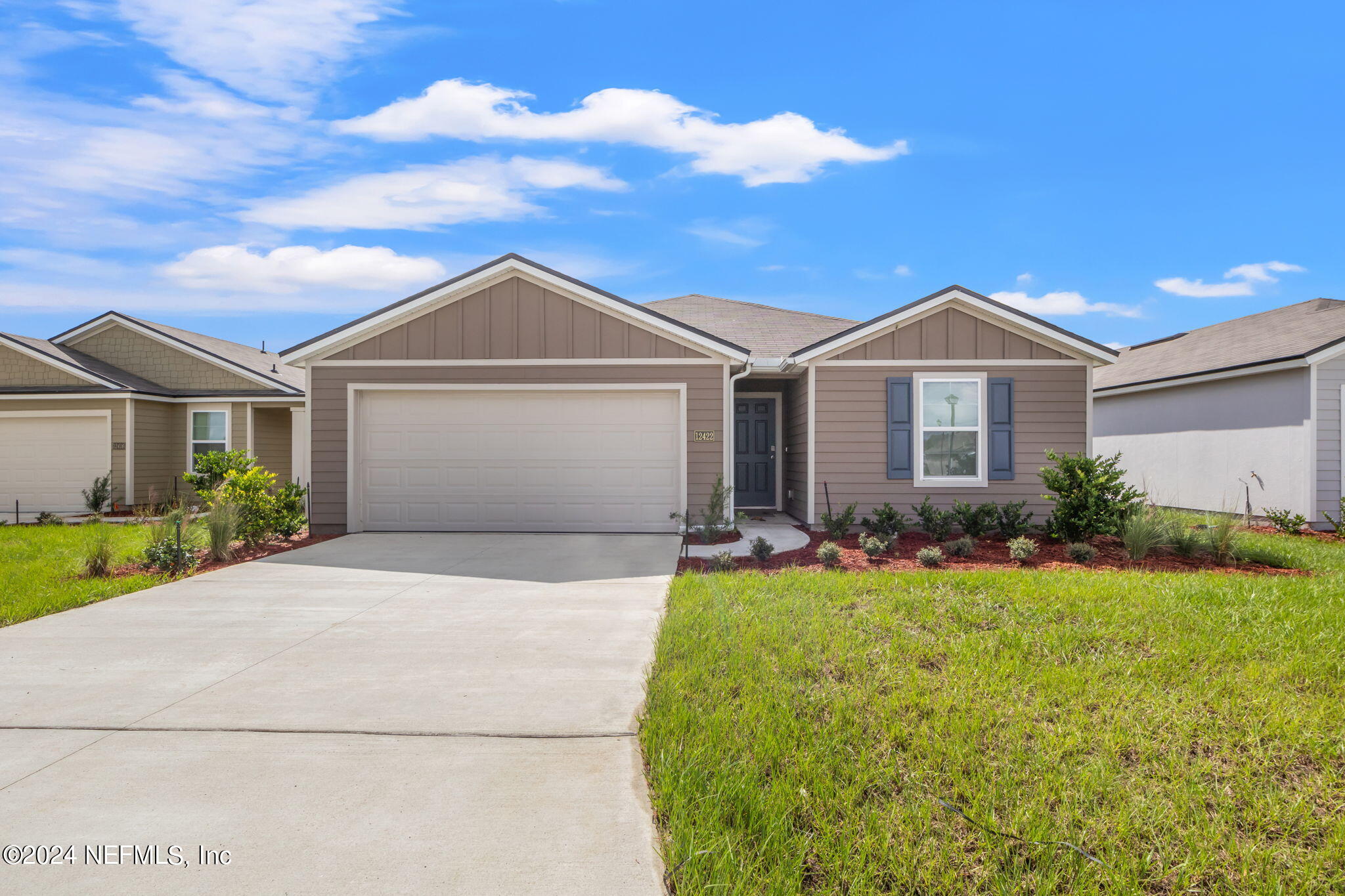 a front view of a house with a yard and garage