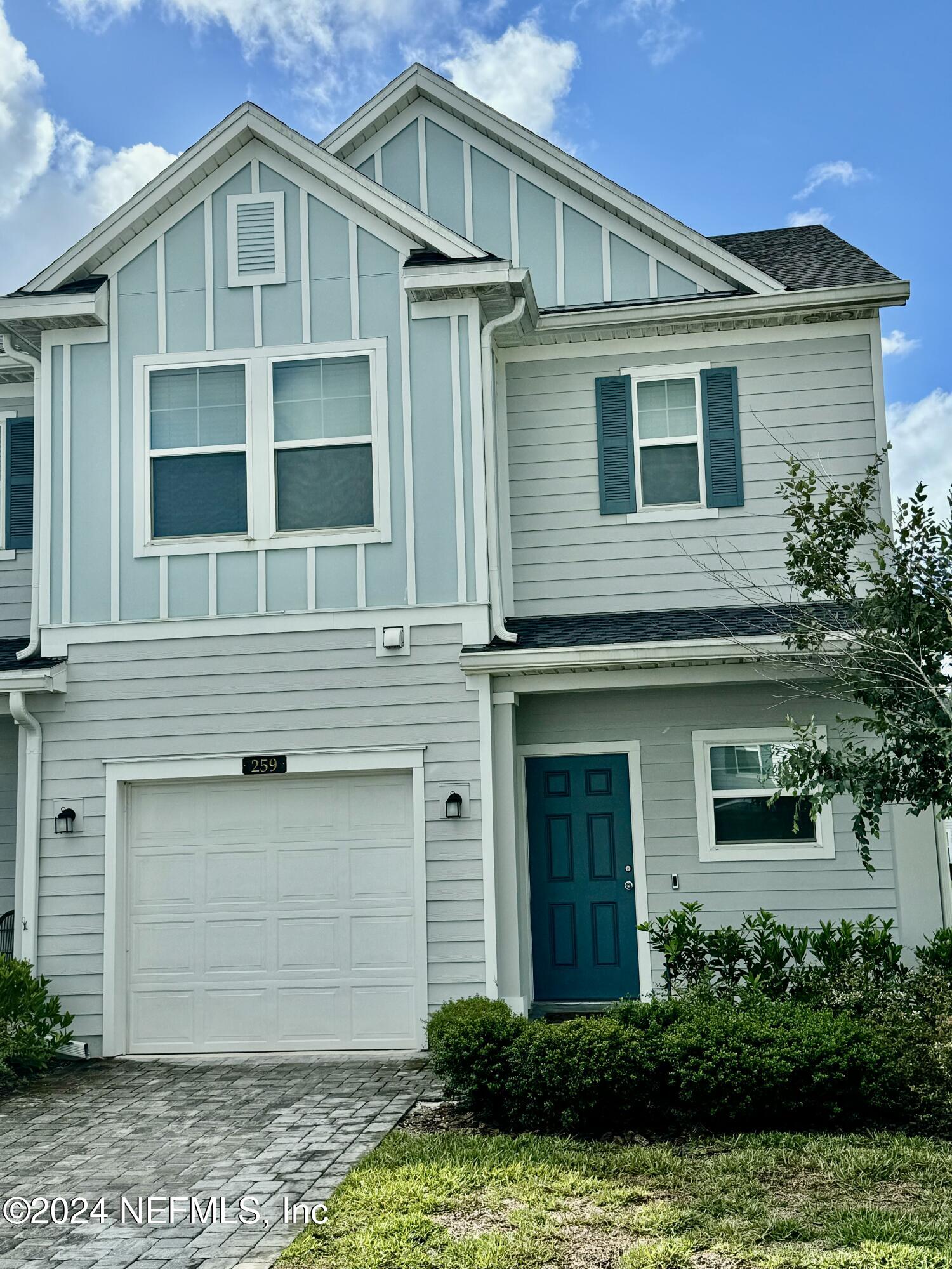 a front view of a house with a yard garage and outdoor seating