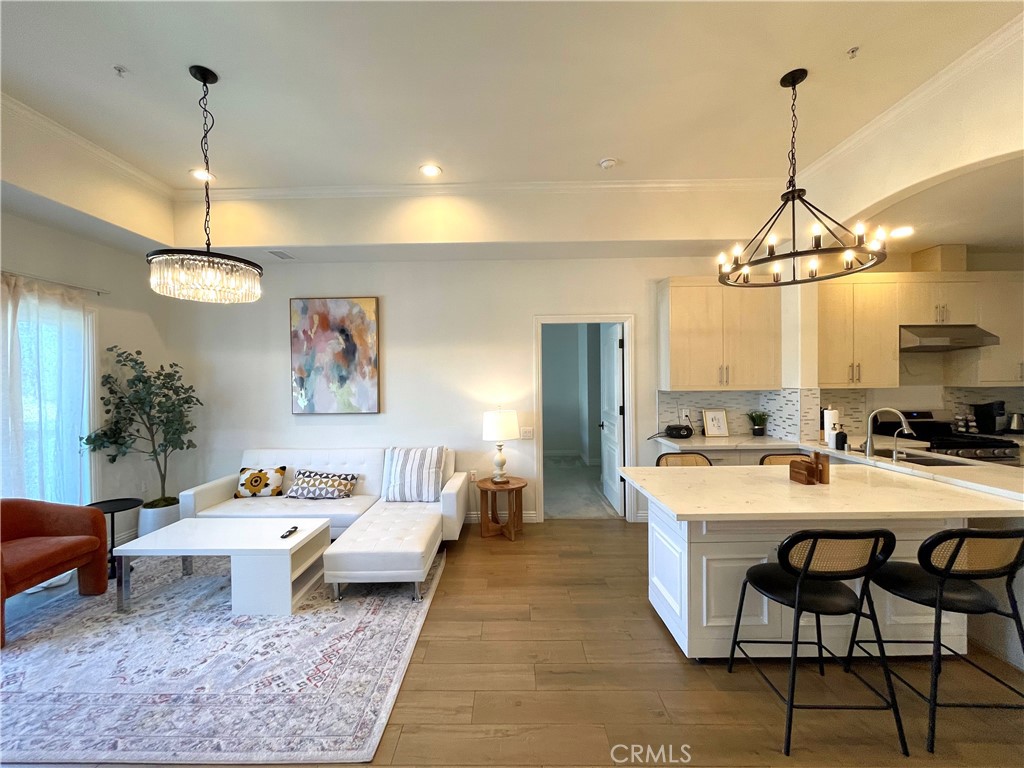 a living room with furniture a chandelier and a table