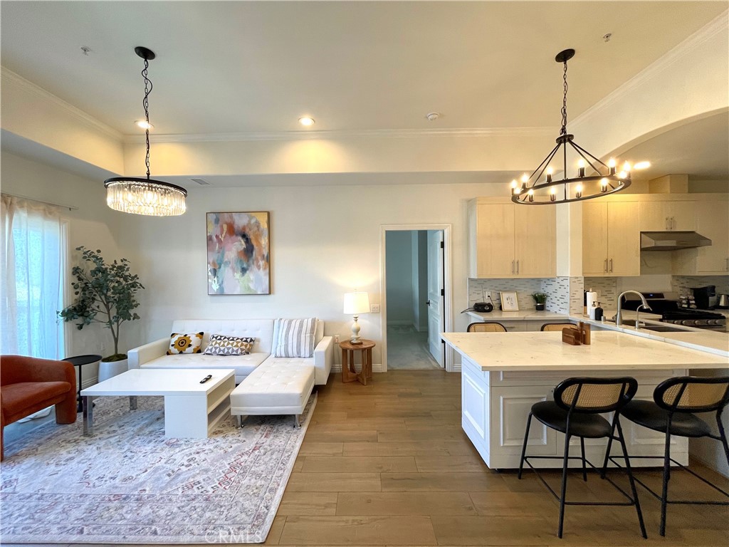 a living room with furniture a chandelier and a table