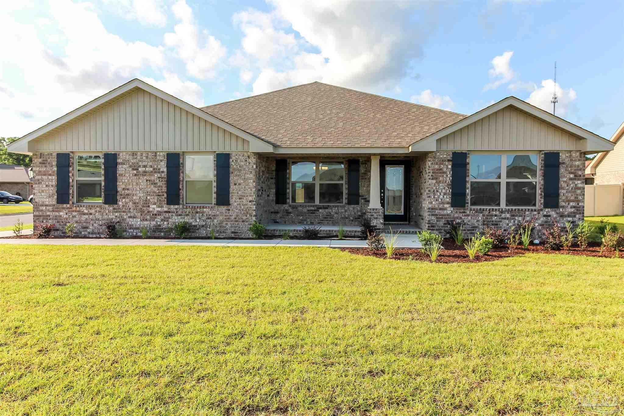 a front view of house with yard outdoor seating and barbeque oven