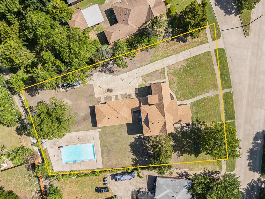 an aerial view of a house with a yard and trees