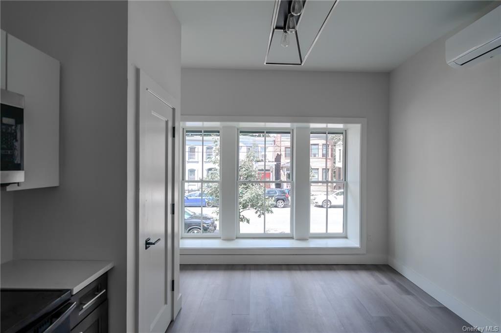 Living room with wood-type flooring and a healthy amount of sunlight