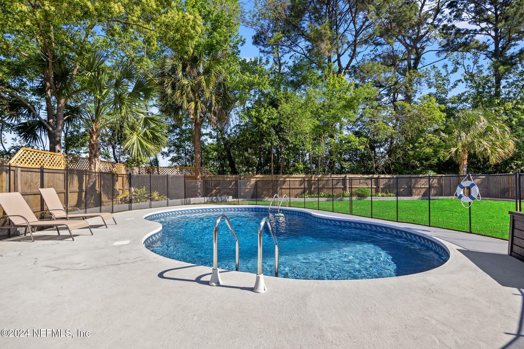 a view of a swimming pool with a sitting area