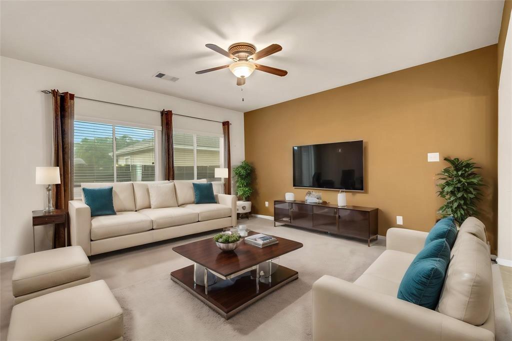 a living room with furniture and a large window