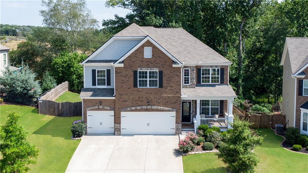 a aerial view of a house with yard and green space