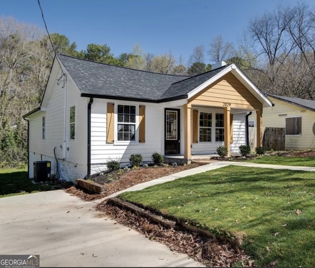 a front view of a house with a yard outdoor seating and garage