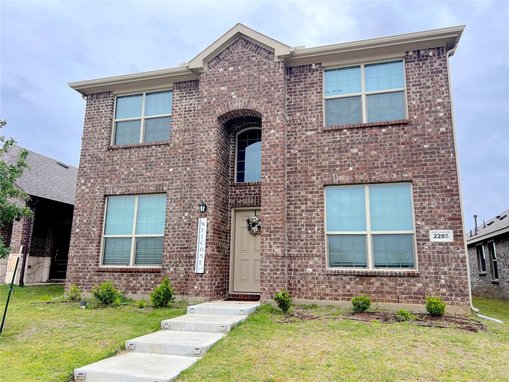 a front view of a house with a yard