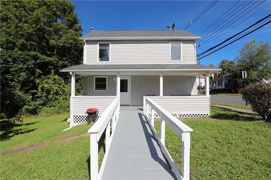 View of front of home featuring a front yard and a porch