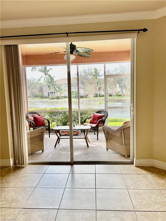 a living room with patio furniture and a floor to ceiling window