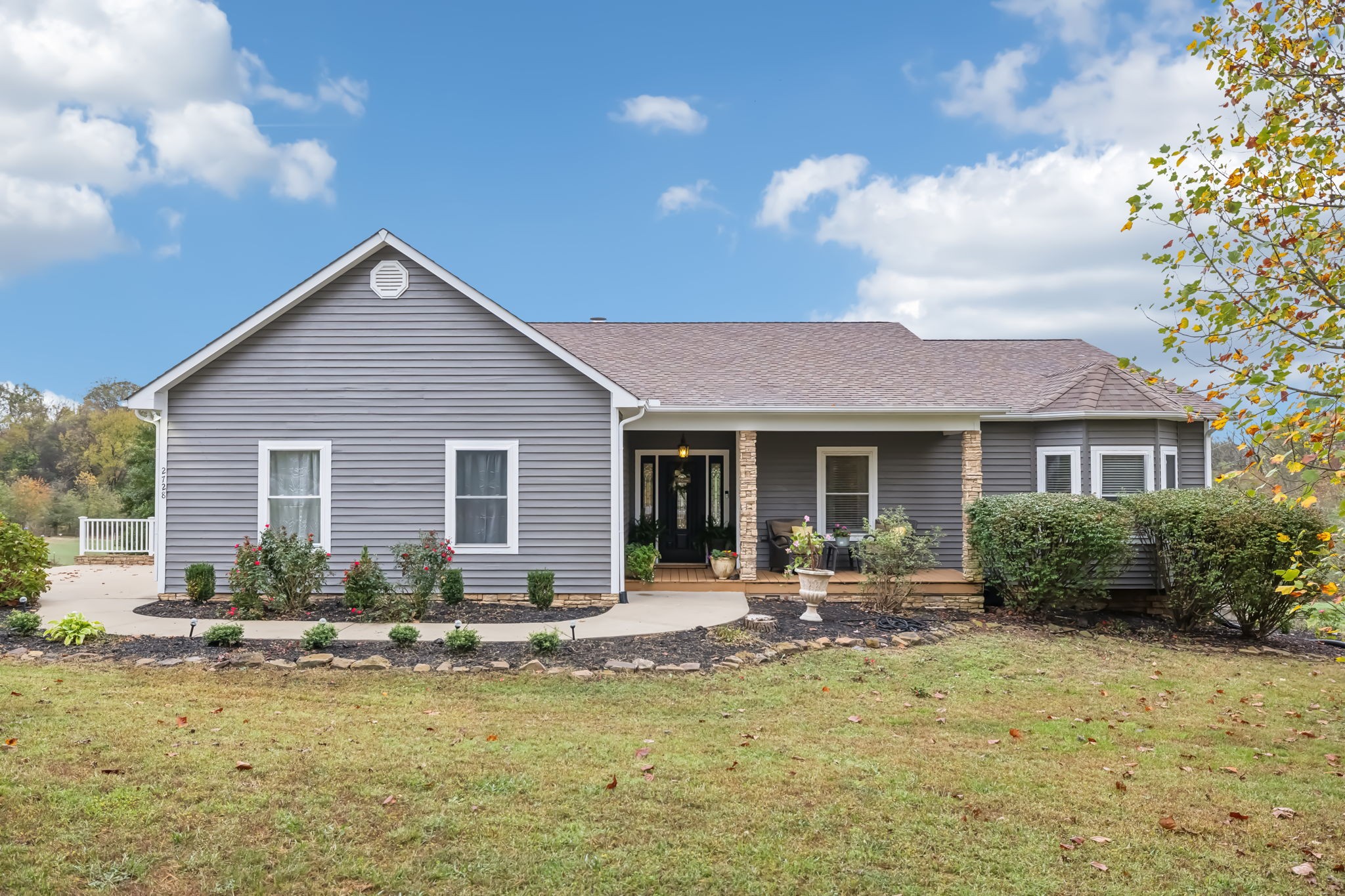 a front view of house with yard outdoor seating and barbeque oven