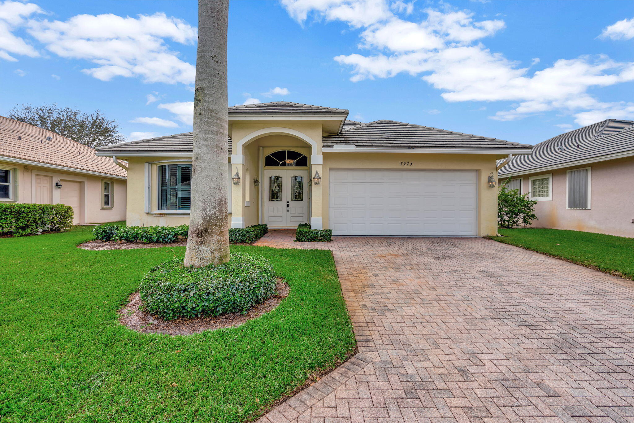 a front view of a house with a yard and garage