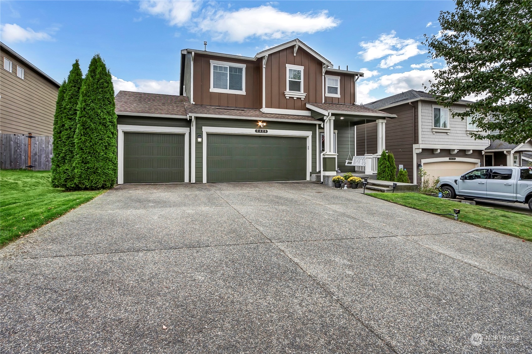 a front view of a house with a yard and garage