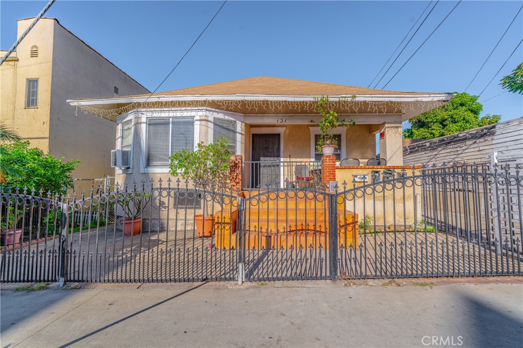 a front view of a house with a iron gate