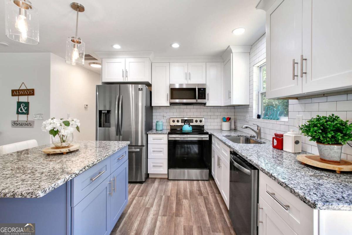 a kitchen with sink a microwave and cabinets