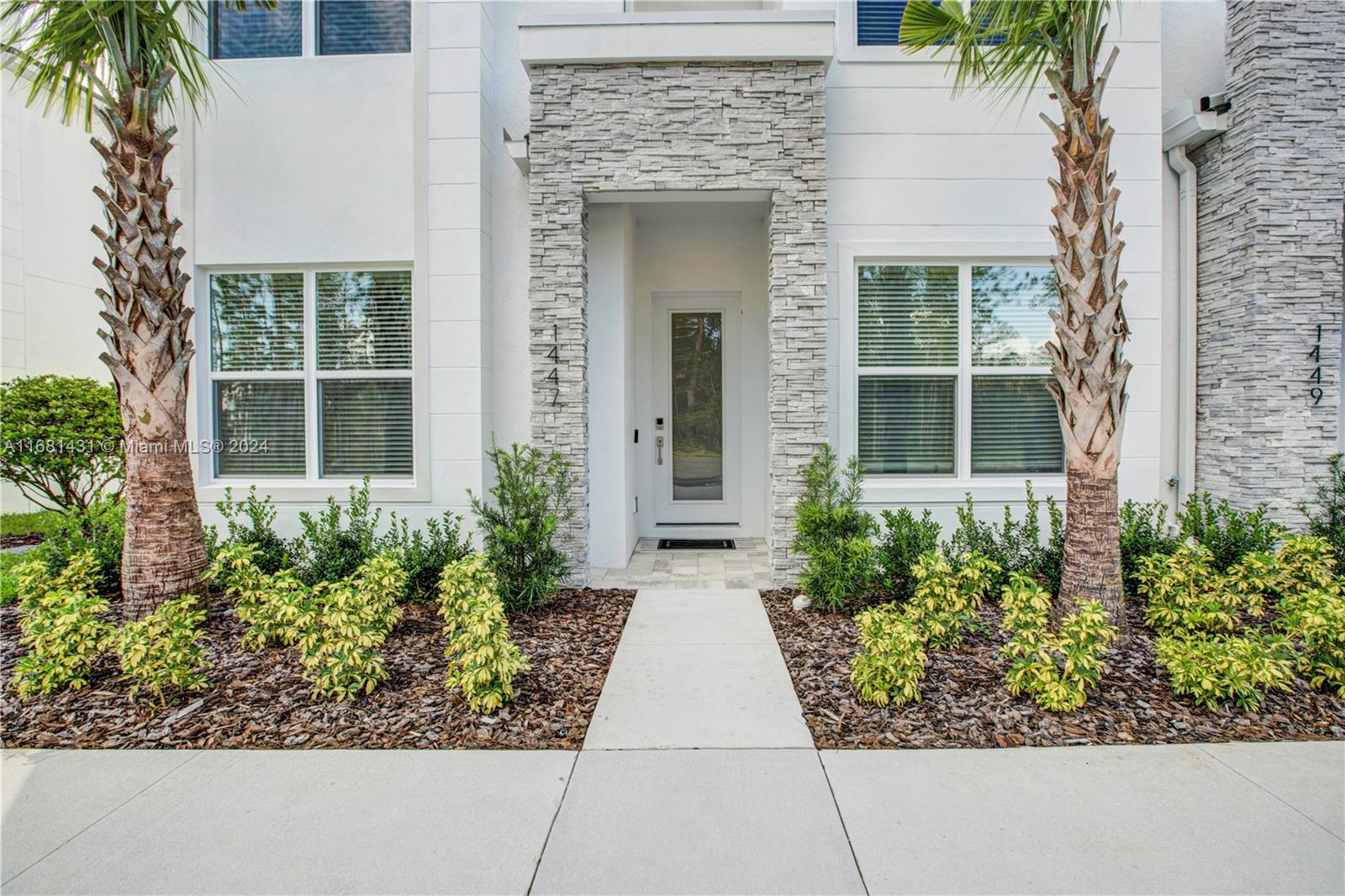 front view of a house with potted plants