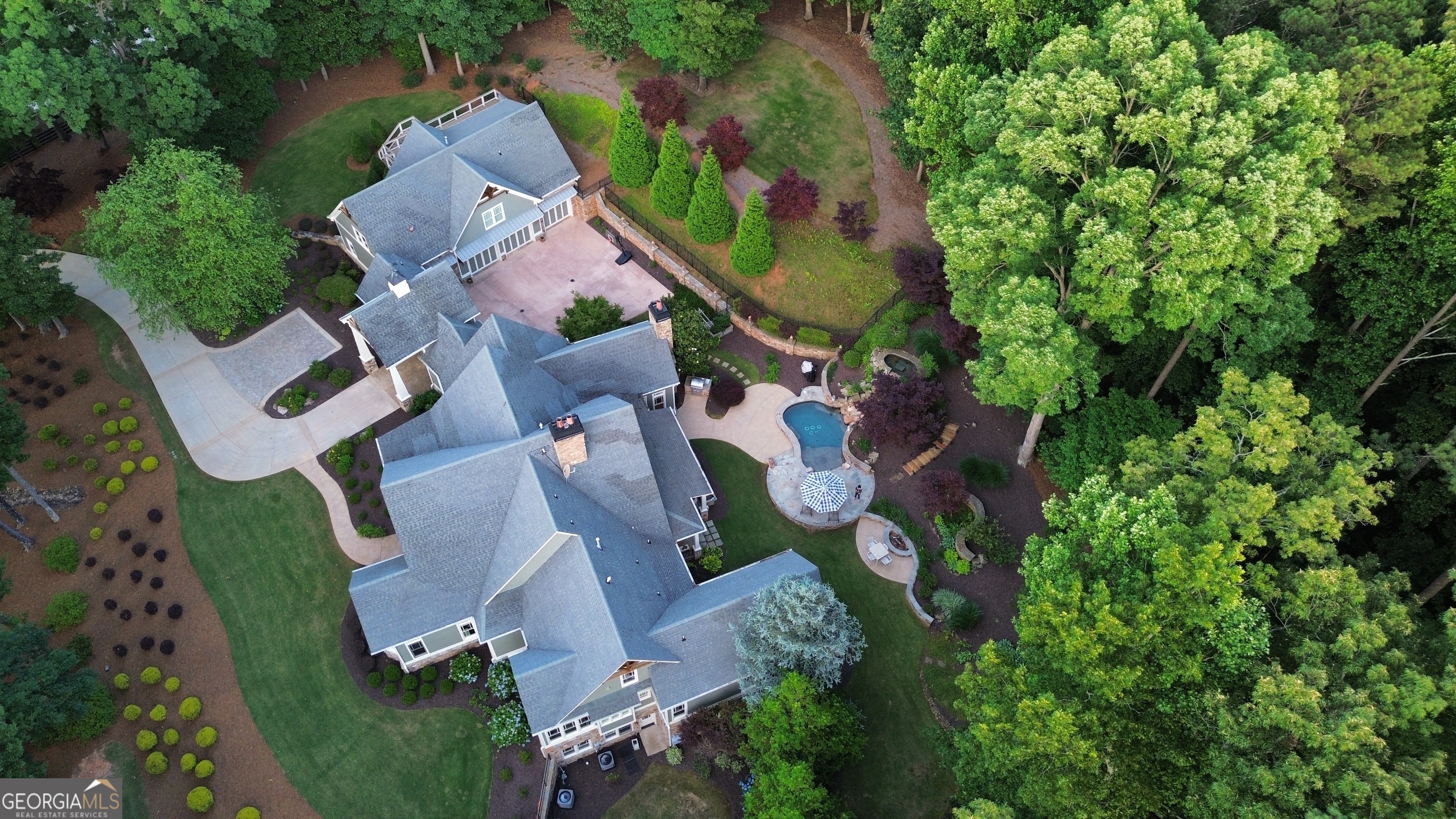 an aerial view of residential house with outdoor space and swimming pool