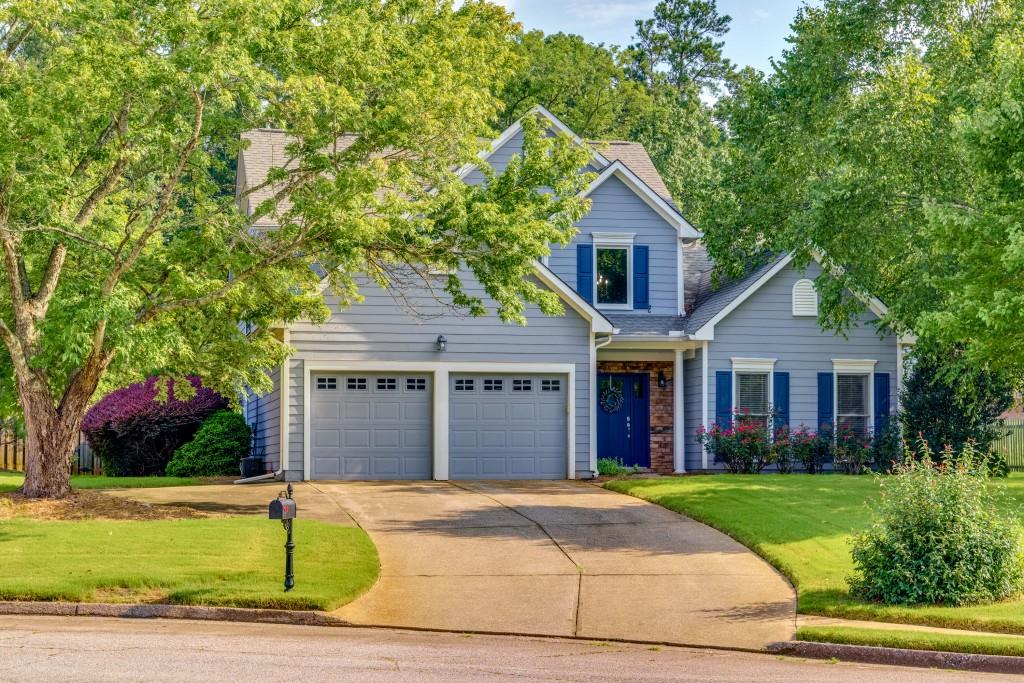 a front view of a house with a yard and garage