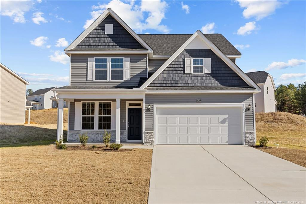 a front view of a house with a yard and garage