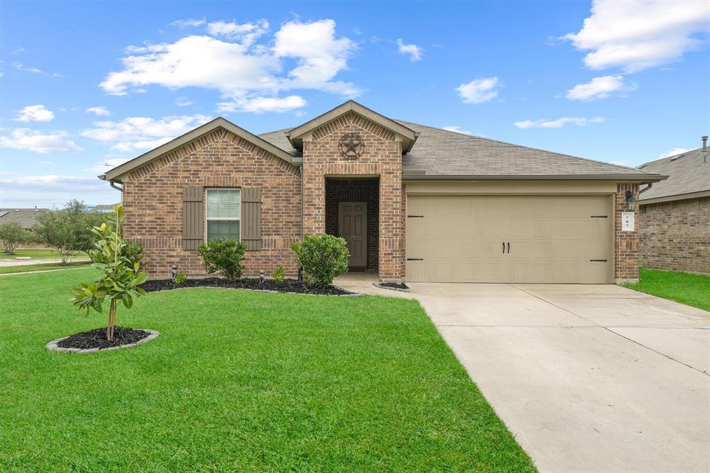 a view of a house with a yard and garage