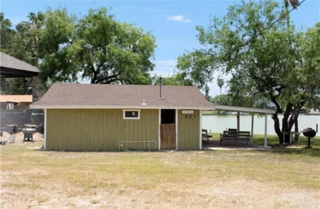 Back of house featuring a lawn