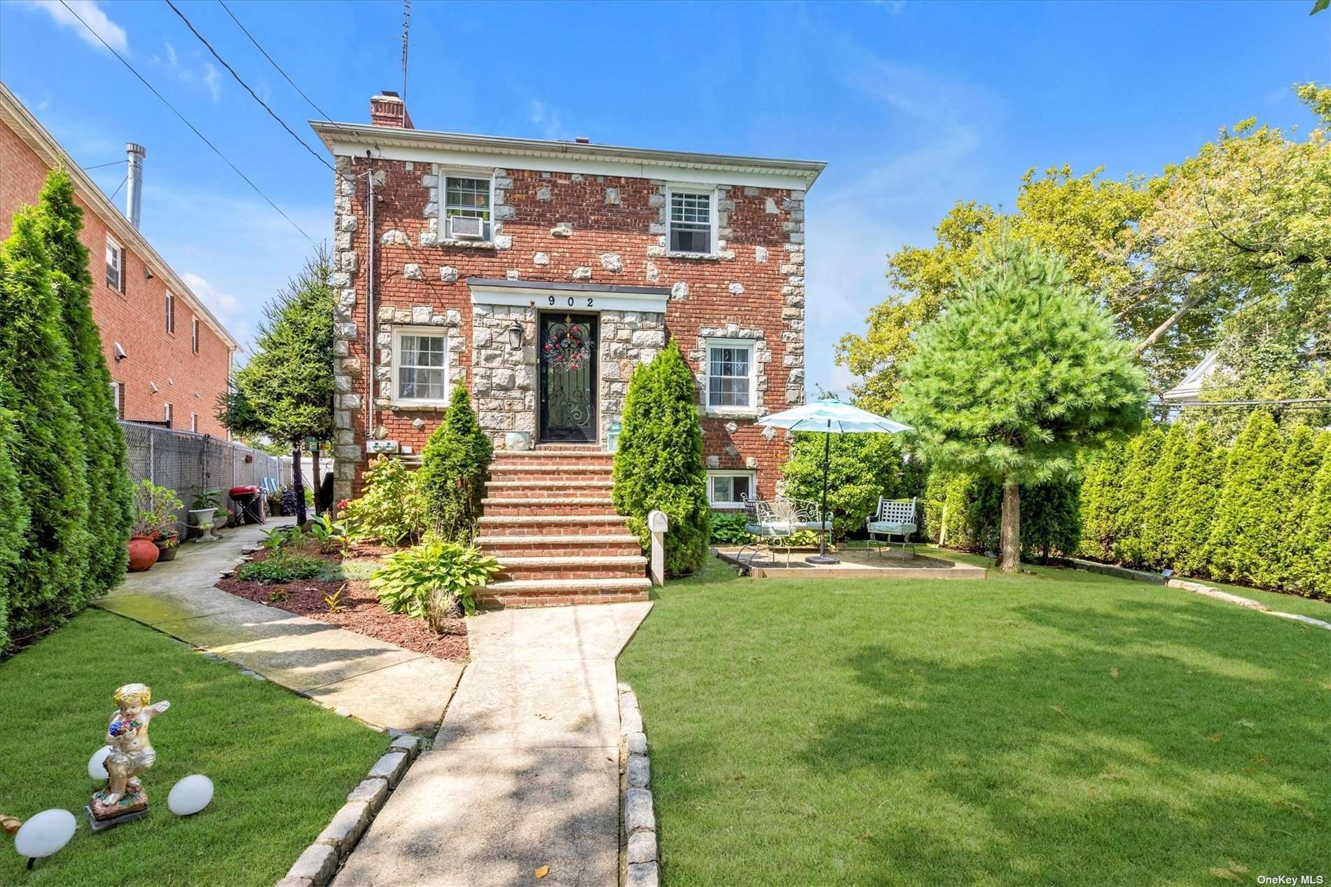 a front view of a house with garden