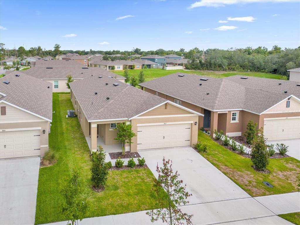 an aerial view of a house with a yard