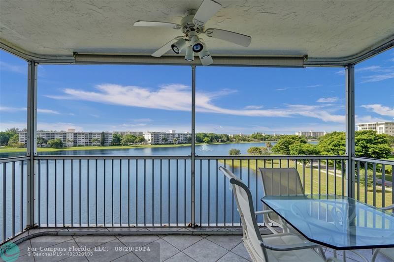 a view of a balcony with couches and wooden floor