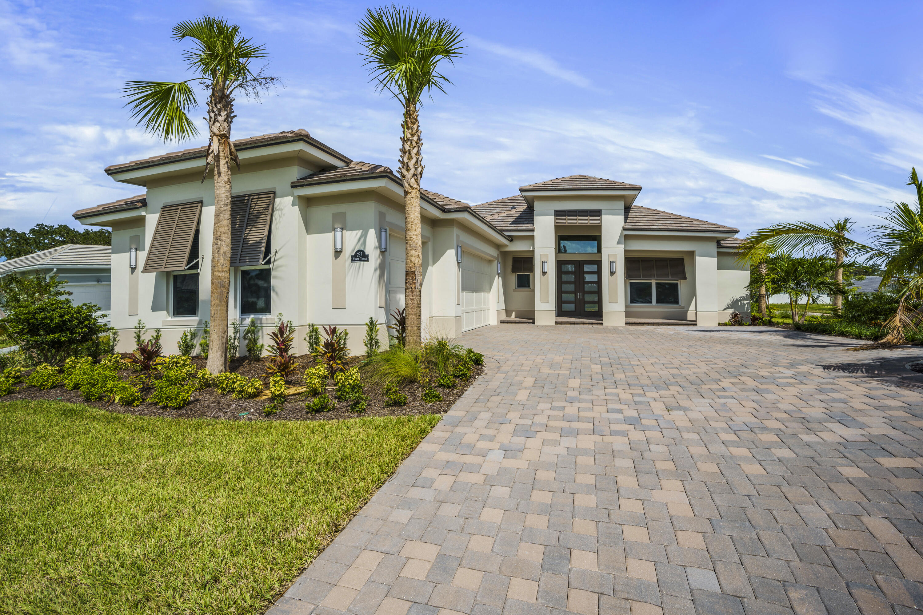 a front view of a house with a garden