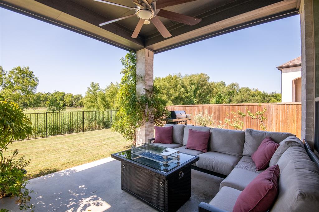 a roof deck with a table and chairs