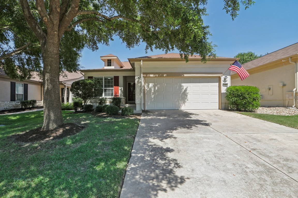 Large tree shades the front of 107 Muir Ct in Sun City Georgetown