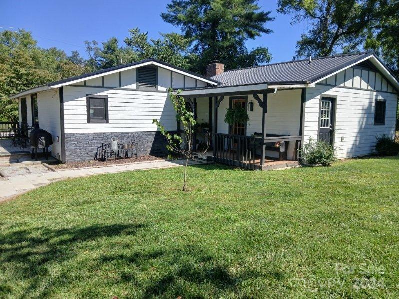 a front view of a house with yard and green space