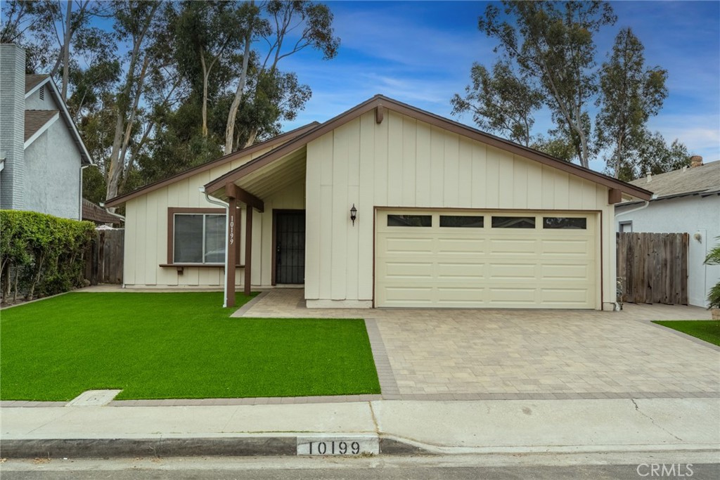 a view of a house with a yard garage and outdoor seating