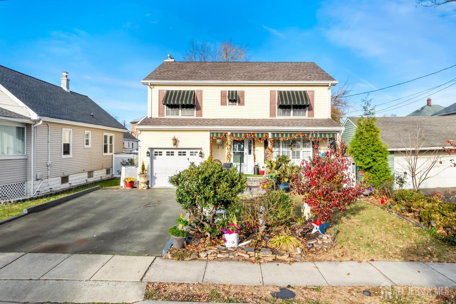 a front view of a house with a garden