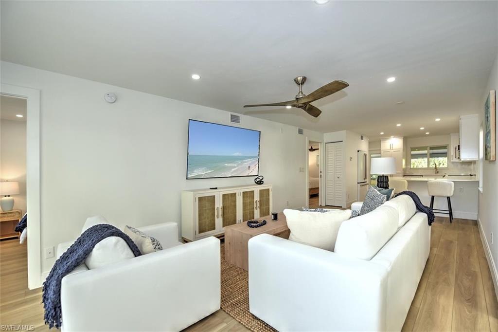 a living room with furniture and a ceiling fan