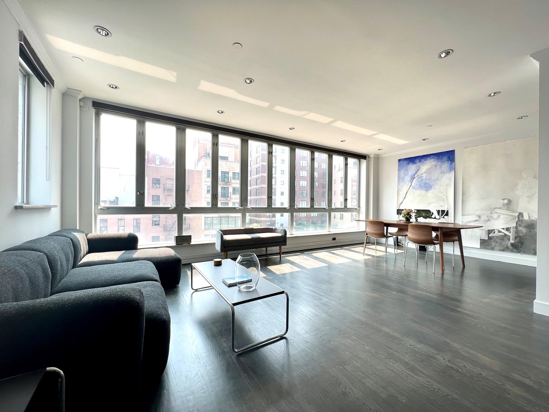 a living room with furniture and floor to ceiling window