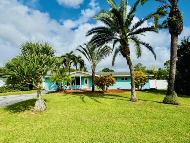 a view of a house with swimming pool and sitting area