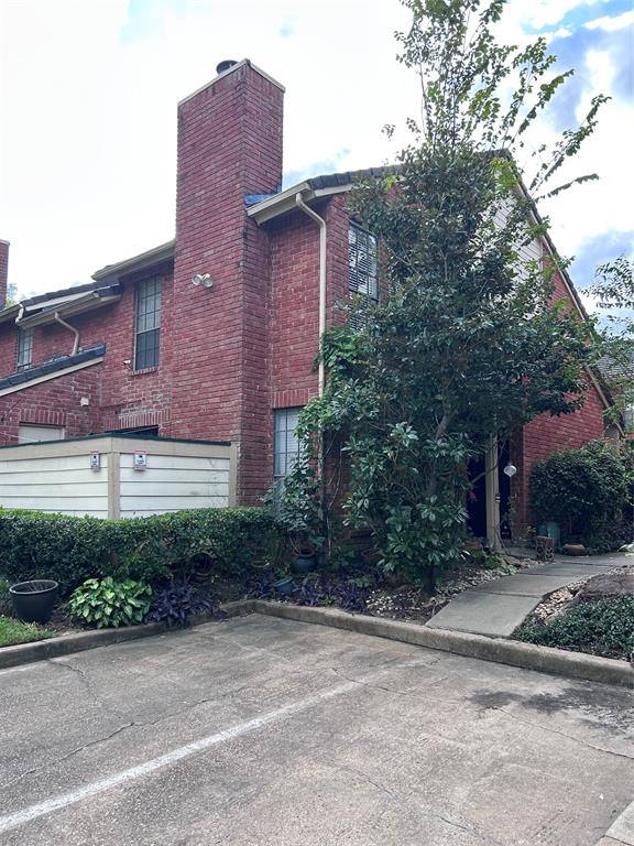 a view of a brick building next to a yard