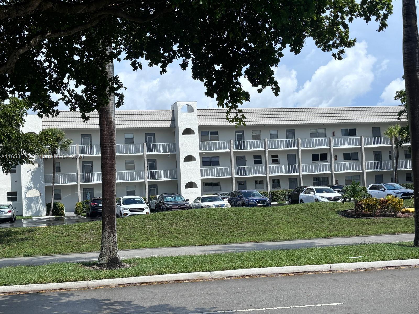 a front view of a building with a yard