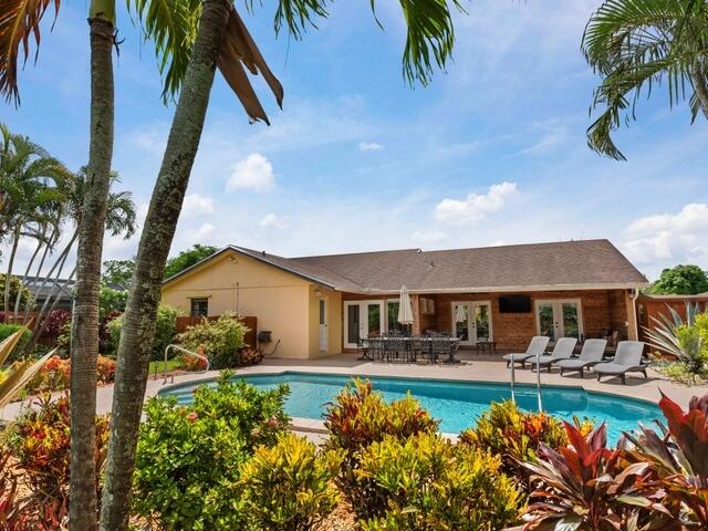 a front view of house with yard and outdoor seating