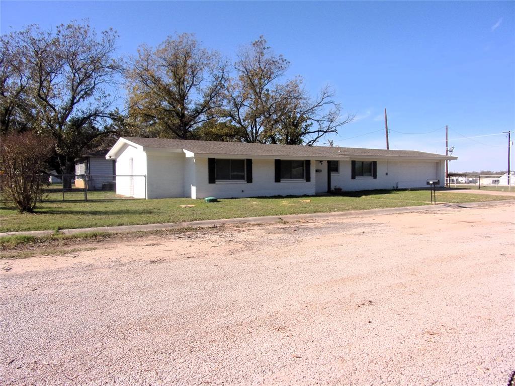 a view of a house with a yard and trees