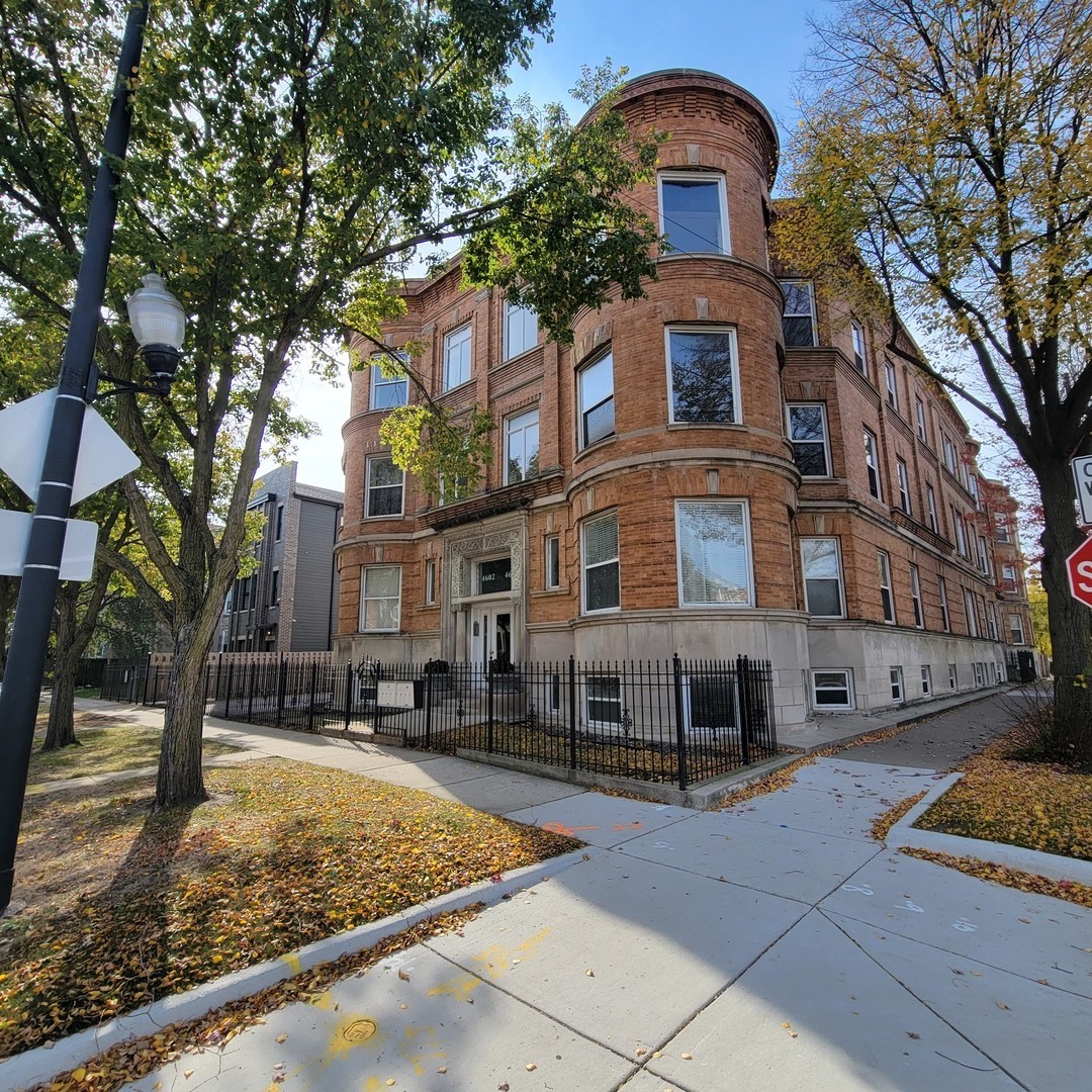 a front view of a residential apartment building with a yard