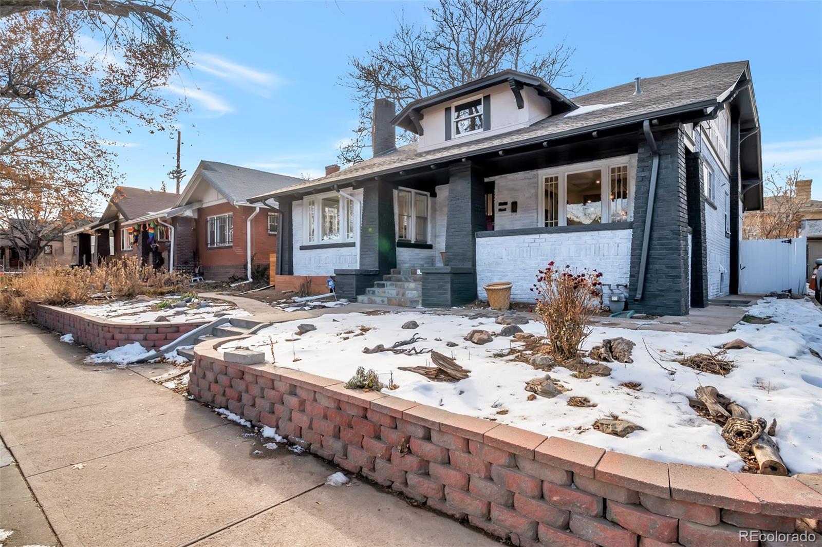 a view of a house with a yard covered in snow