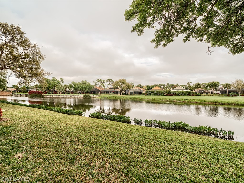 a view of a lake with houses in the back