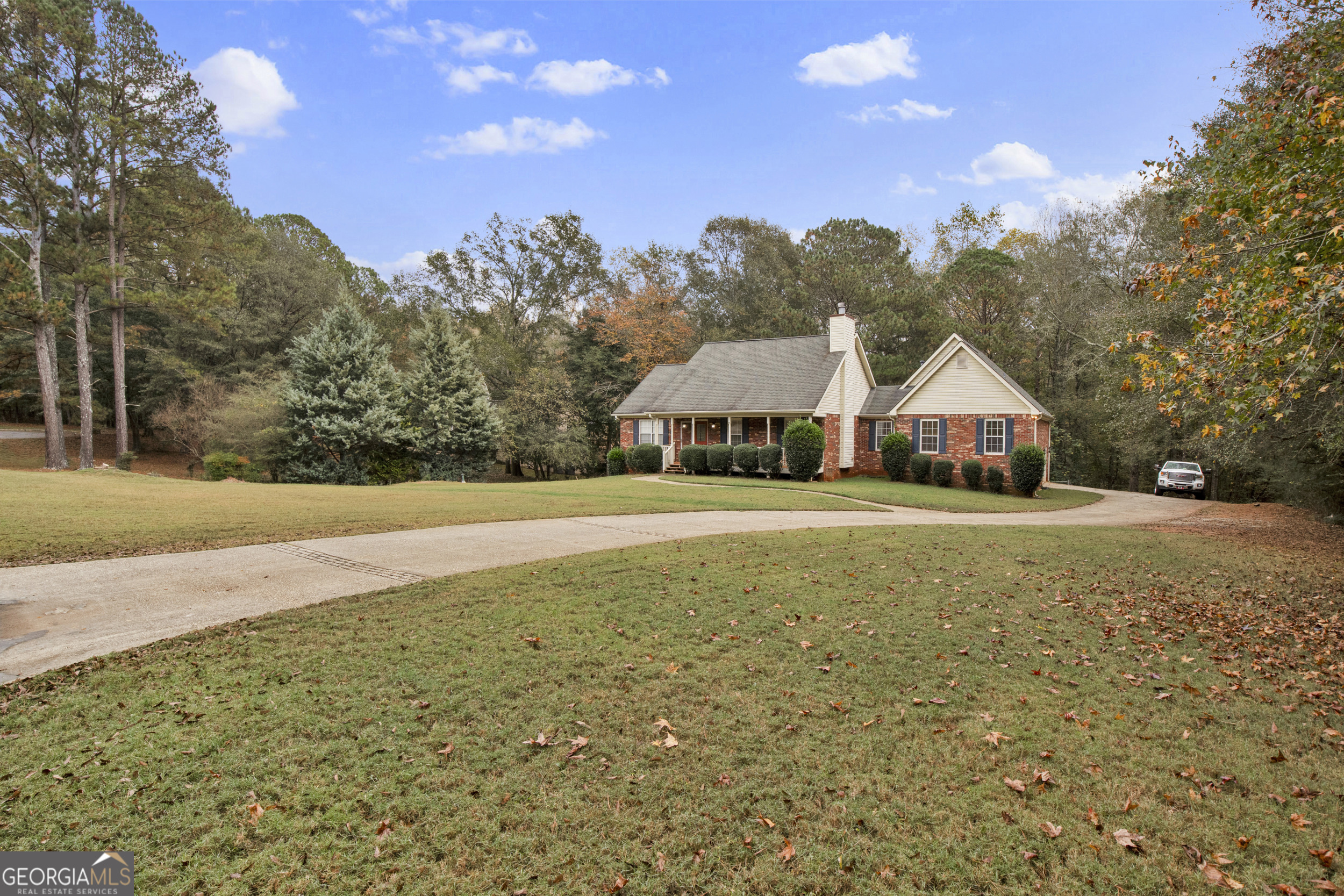 a front view of house with yard and trees