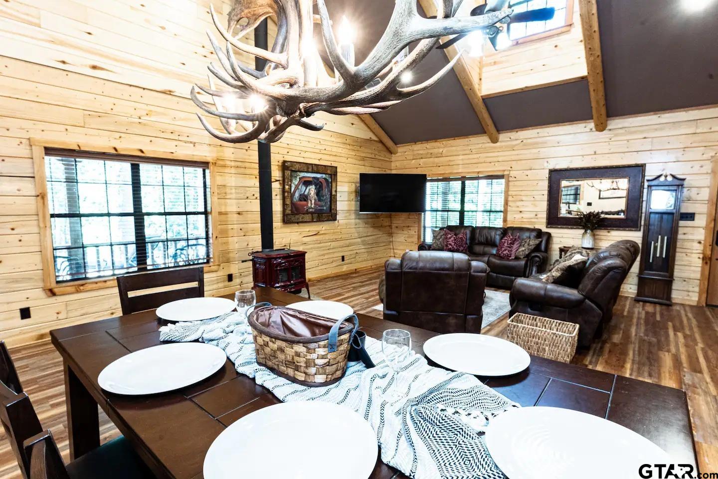 a living room with furniture a fireplace and a ceiling fan