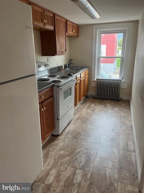 a kitchen with stainless steel appliances granite countertop a sink stove and a refrigerator